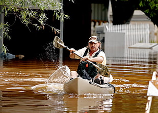 man paddling kayak on brown water river HD wallpaper