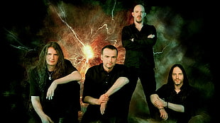 four men wearing black clothes