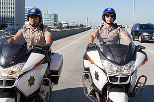 two policemen riding white and black touring motorcycle