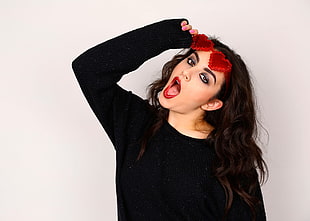 woman wearing black long-sleeve shirt and red fashion eyeglasses