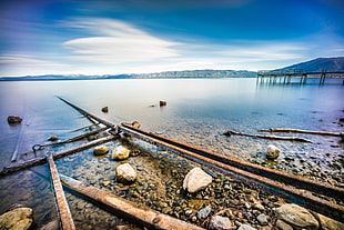 black metal bar lot on top of rocks beside body of water, lake tahoe, california