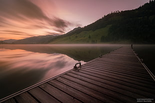 timelapse photo of brown wooden bridge on still lake, lac