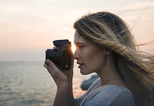 closeup photo of woman holding a camera