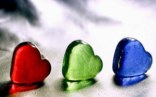 three blue, green, and red heart stone decors