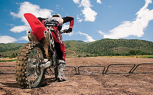 man riding on motocross dirt bike near mountain