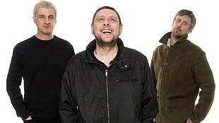 group of three men wearing zip-up jacket and sweater