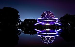 purple and white LED concrete building, night, artificial lights