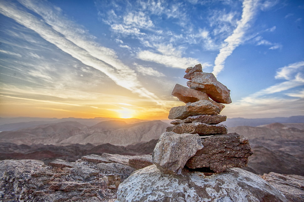 stack of rocks under blue skies HD wallpaper