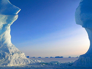 photo of ice island near body of water
