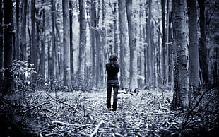 woman wearing black shirt walking in The woods