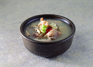 meat soup on black ceramic bowl