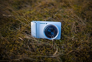 silver Samsung digital camera on green grass
