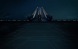 silver escalator during night time