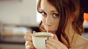 woman holding white ceramic tea cup HD wallpaper
