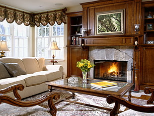 lighted fireplace with sofa on living room