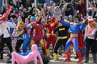 group of people wearing super heroes costumes dancing during daytime