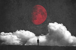 silhouette of man standing under red full moon overlooking clouds illustration