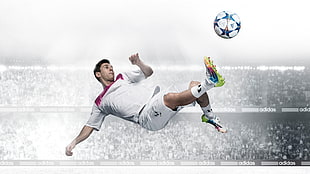 sports photography of soccer player suspended in air