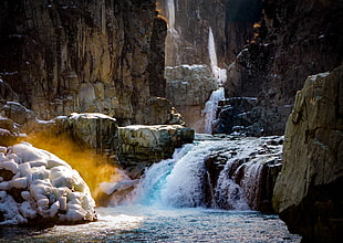 waterfalls near cliff at daytime