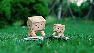 two box illustration reading book on grass