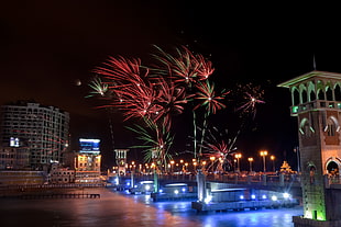 fireworks display near on high rise buildings HD wallpaper
