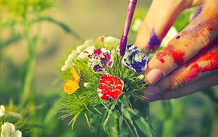 person coloring flower