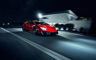 red Lamborghini Huracan on concrete road HD wallpaper