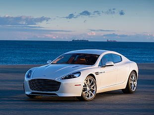 white Aston-Martin sedan parked near sea