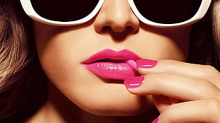 woman wearing white sunglasses with pink lipstick
