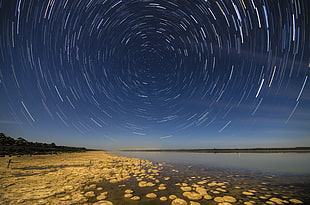 timelapse photo of star over calm body of water, lake clifton HD wallpaper