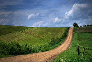 brown road between green grass under cloudy skies, pennsylvania