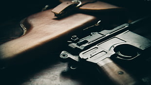 shallow focus photography of gun and sheath