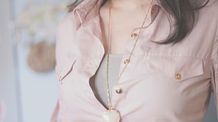 gold-colored pendant with necklace