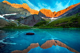 landscape photo of mountain and body of water