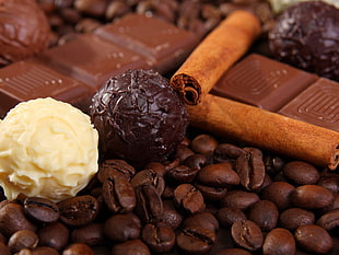 vanilla and chocolate balls beside coffee beans and chocolate bars