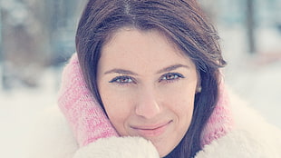 selective photography of woman wearing white jacket and pink knit scarf around neck