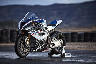 depth of field photography of white and blue HP4 sport bike
