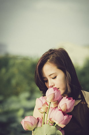 woman snipping flower during day time HD wallpaper