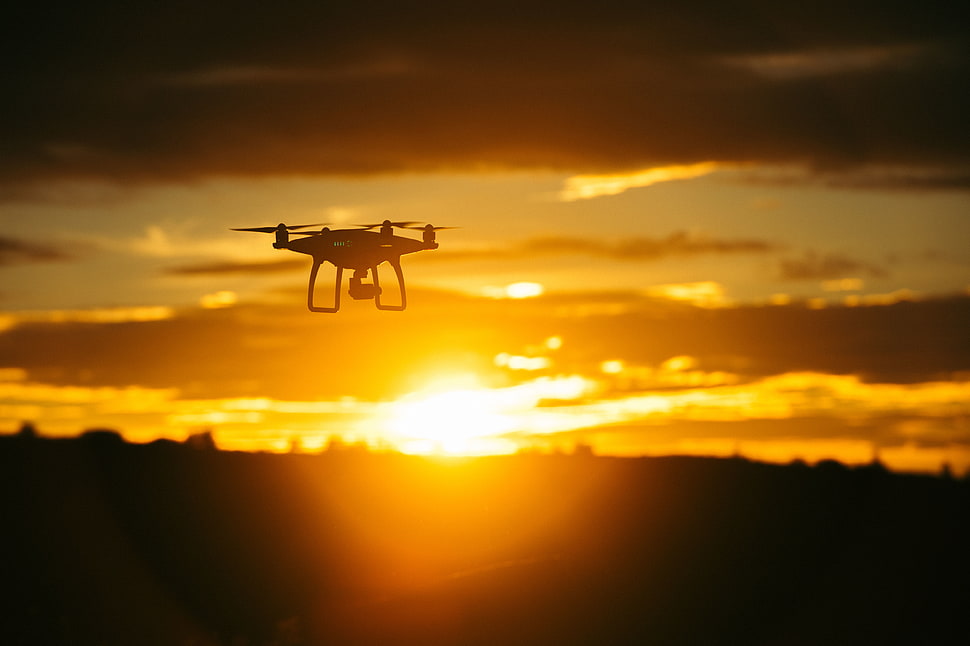 black quadcopter drone in sky HD wallpaper