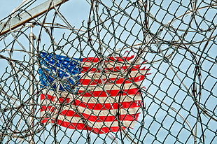 flag of the United States of American near chain link fence