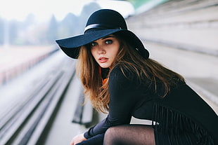 selective focus photo of woman in black sun hat