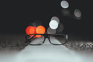 shallow focus photography of clear eyeglasses with black frame