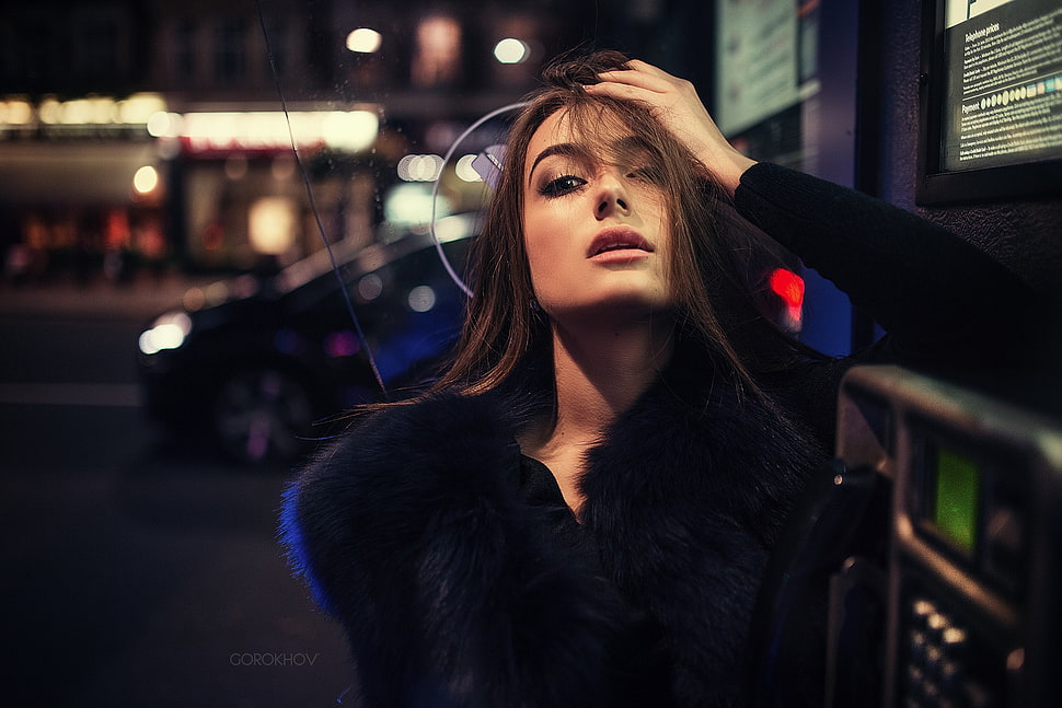 selective focus photography of woman wearing black fur coat during nighttime HD wallpaper
