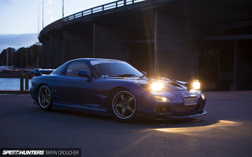 blue coupe with pop-up headlights on road during golden hour HD wallpaper