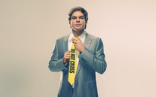 man wearing gray suit jacket with yellow necktie