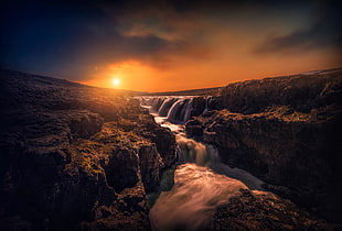 timelapse photography of flowing multi-tier waterfall during sunset