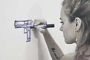 woman drawing semi-automatic pistol