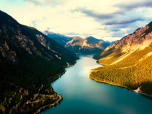 landscape photography of body of water between mountains during daytime