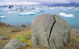 photo of gray rock near body of water