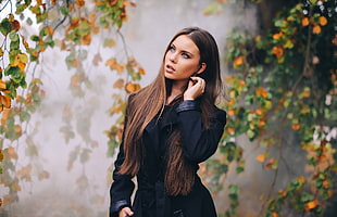 woman wearing black coat scratching her neck HD wallpaper